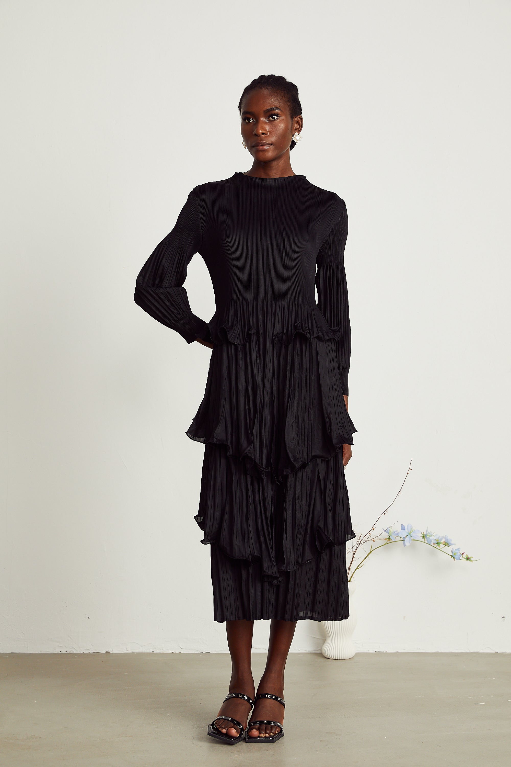 Vestido midi negro con fruncido en capas y pliegues, estilo elegante de MRMelbourne, visible en la imagen.