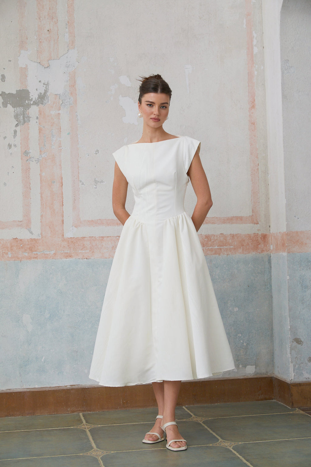 Vestido midi blanco Amandine con espalda abierta y mangas cap, estilo elegante y moderno en imagen.