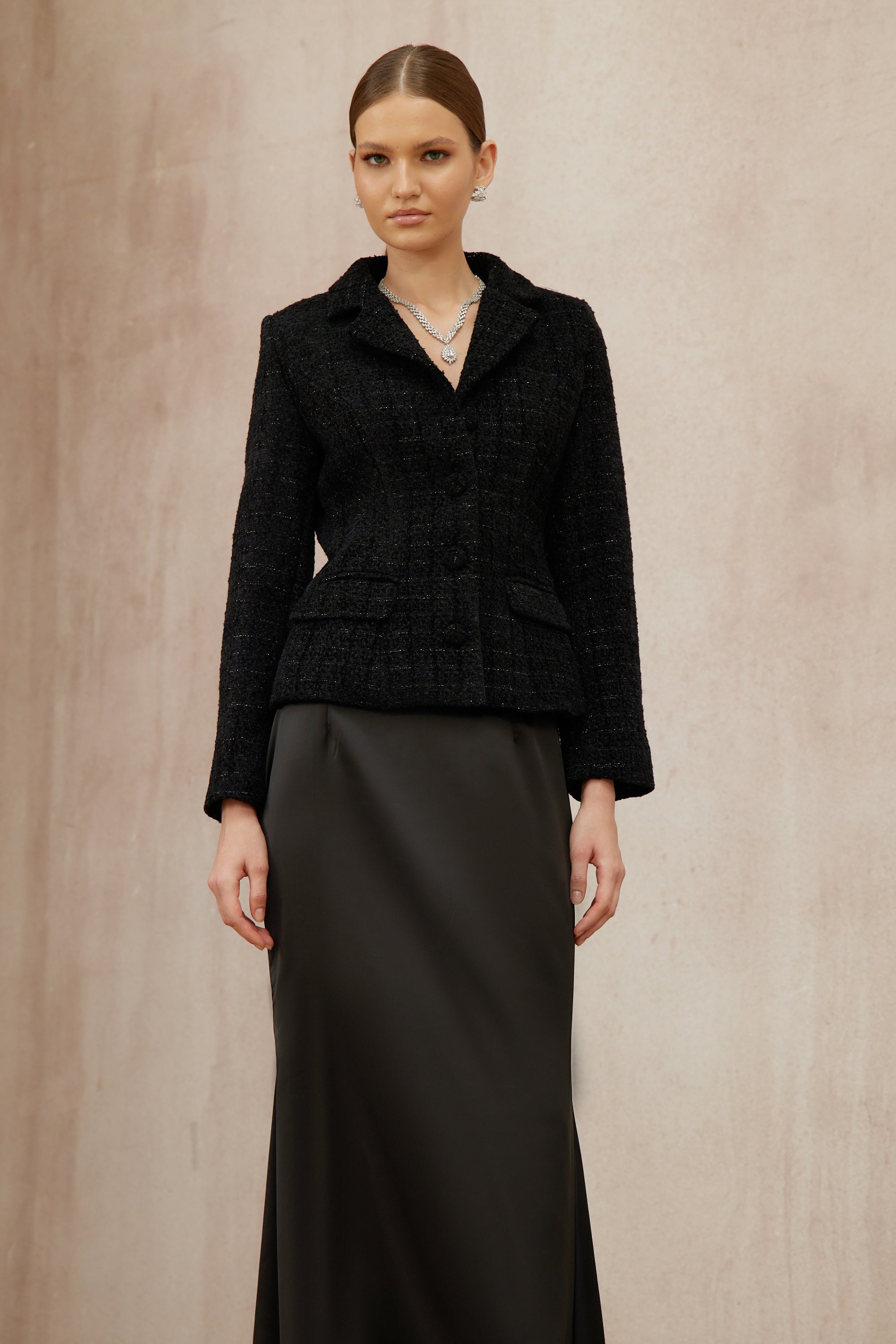 Conjunto de chaqueta de tweed negra y falda de satén de la marca Final Sale, muestra la textura y el diseño elegante del conjunto.