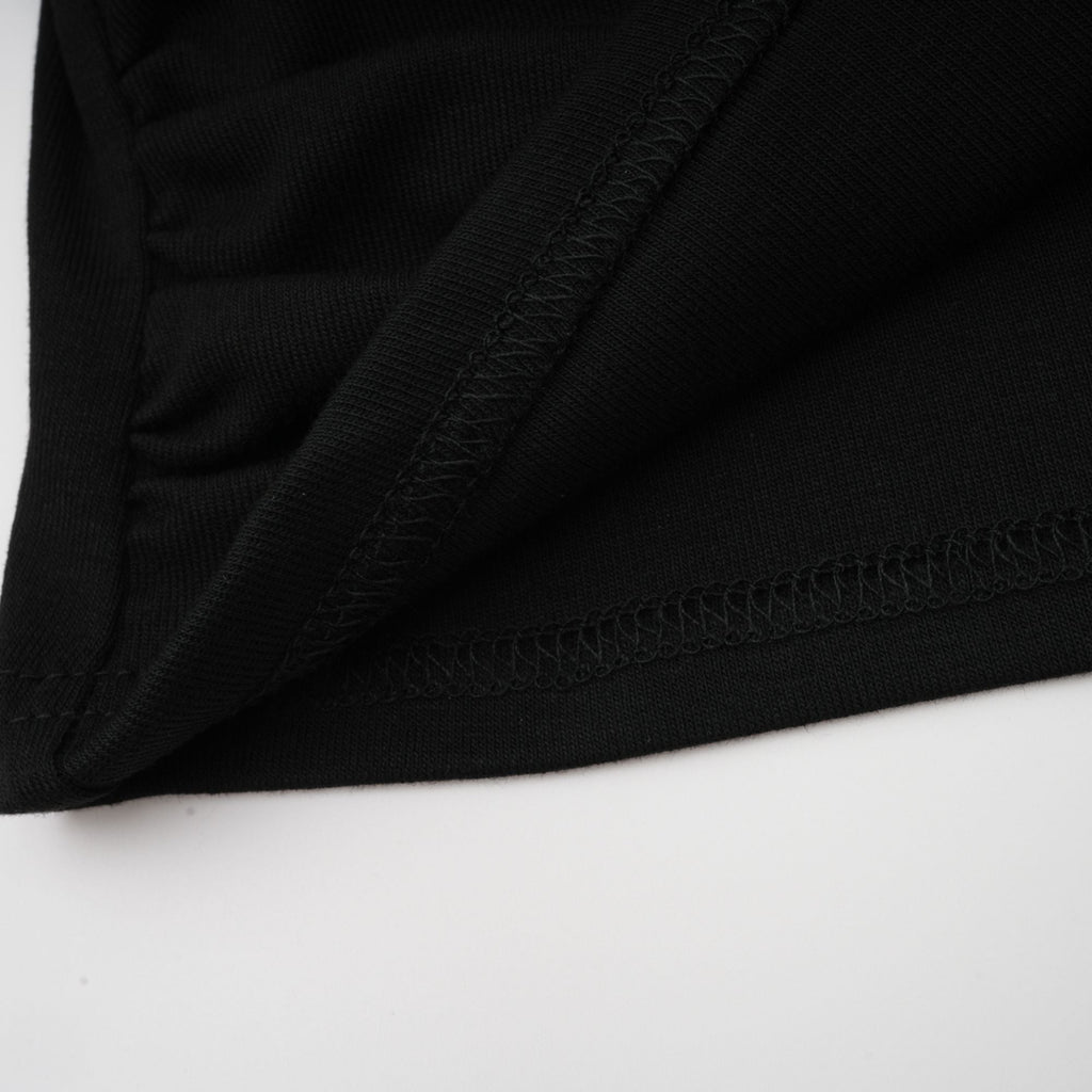 Blusa negra de manga larga con abertura frontal y fruncido, de la marca Final Sale, vista en la imagen.