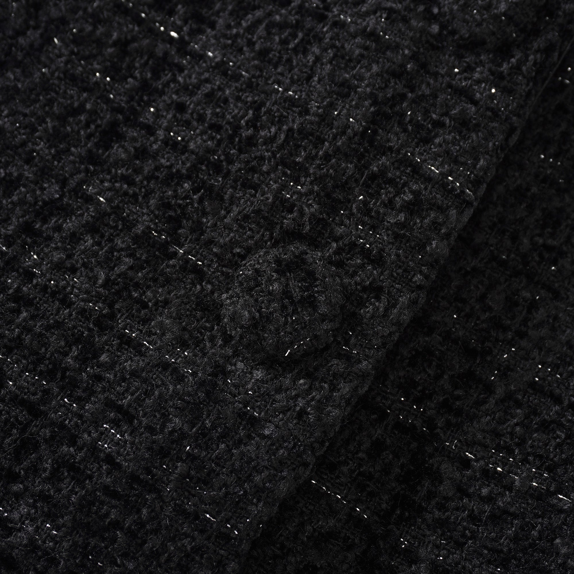Conjunto de chaqueta negra de tweed y falda de satén de la marca Final Sale, vista en la imagen.