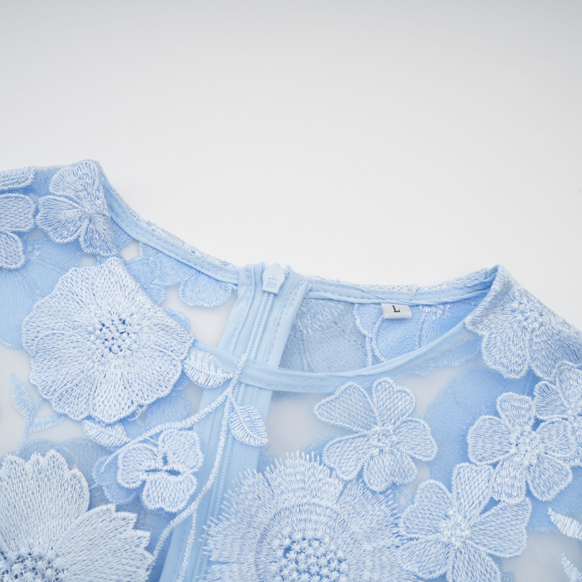 Vestido midi azul con aplicaciones florales de la marca Final Sale, diseñado para un estilo elegante y femenino.