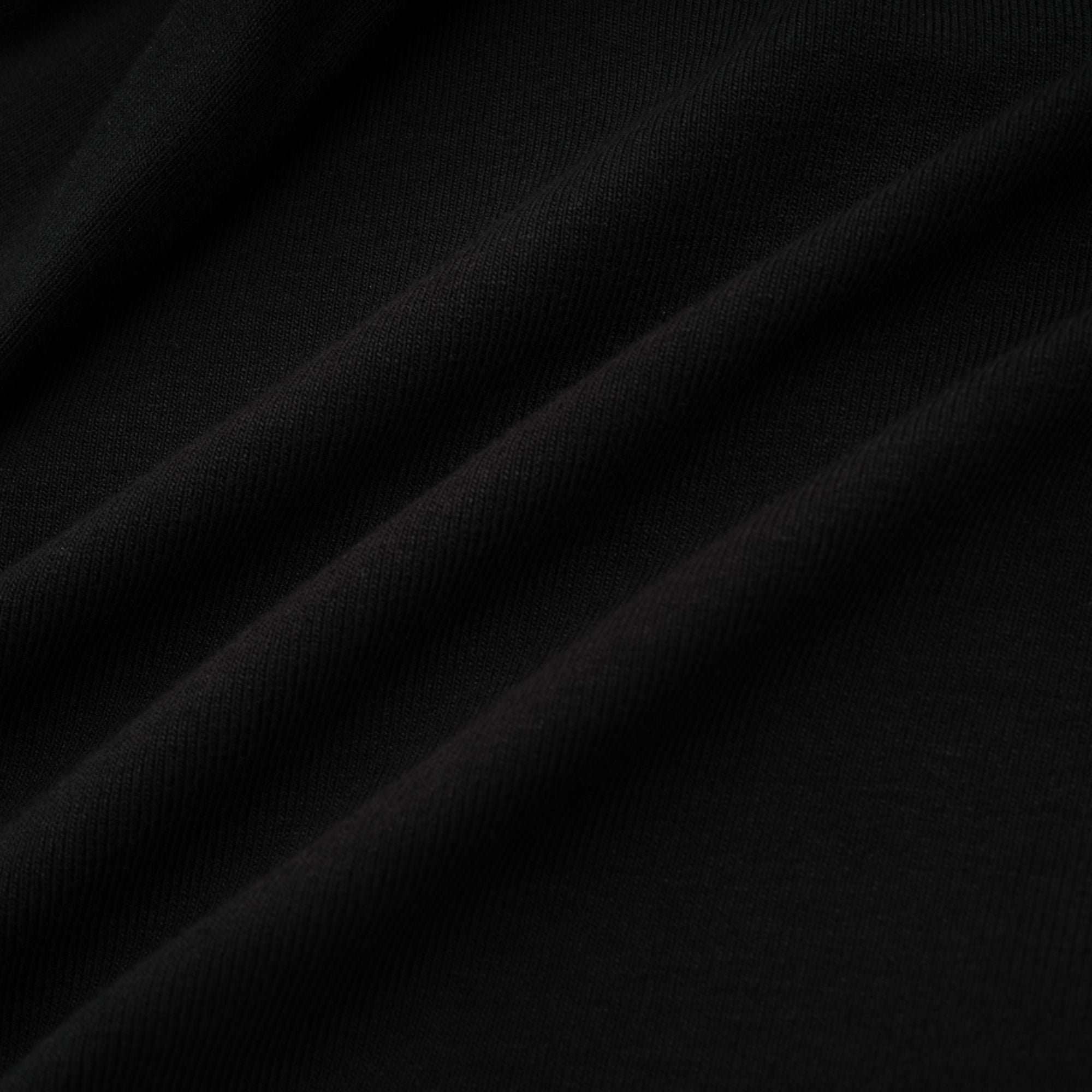 Blusa corta de efecto plisado con recortes en color negro de la marca Final Sale, vista frontal.