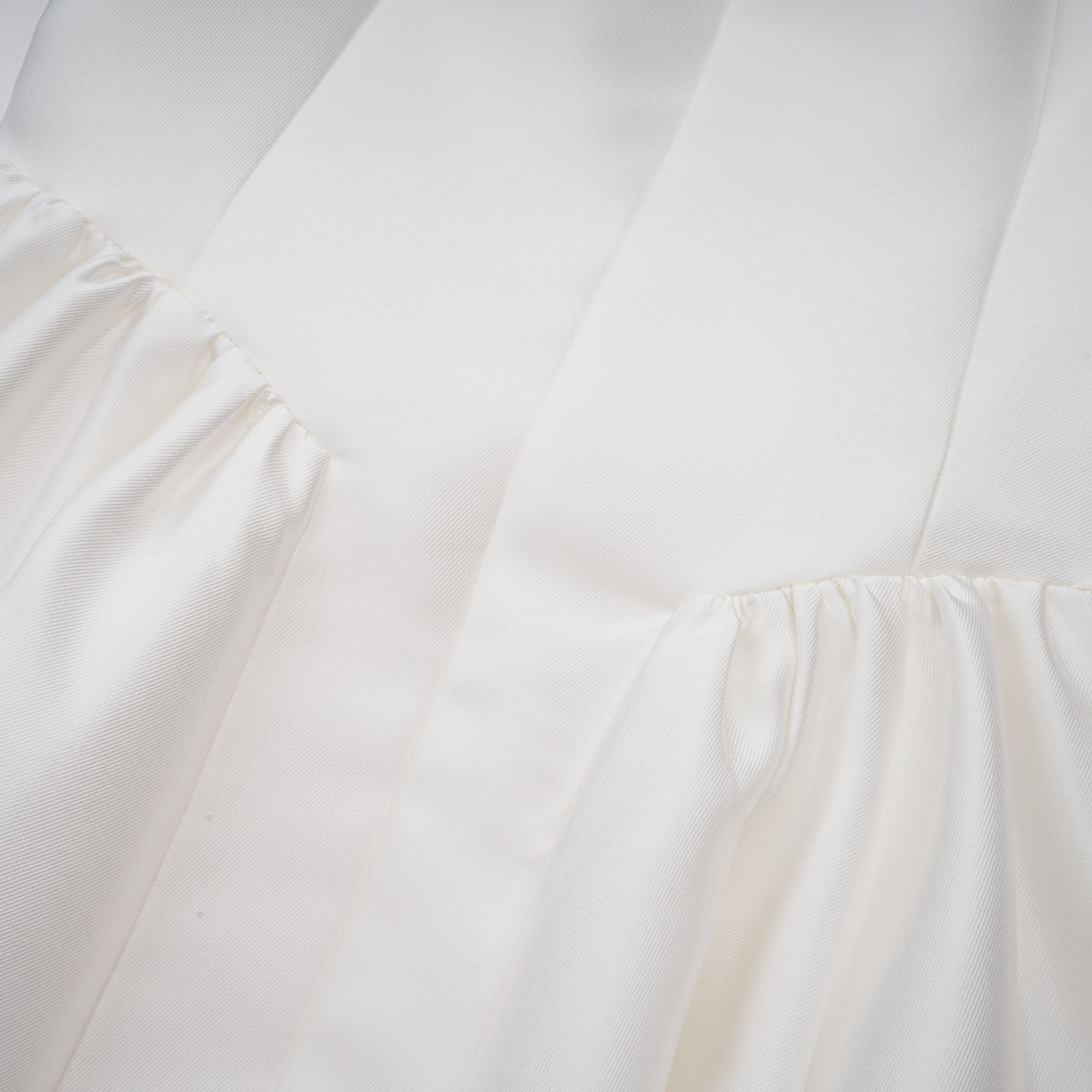 Vestido midi blanco Amandine con espalda abierta y mangas cap en la imagen. Diseño elegante y moderno para ocasiones especiales.